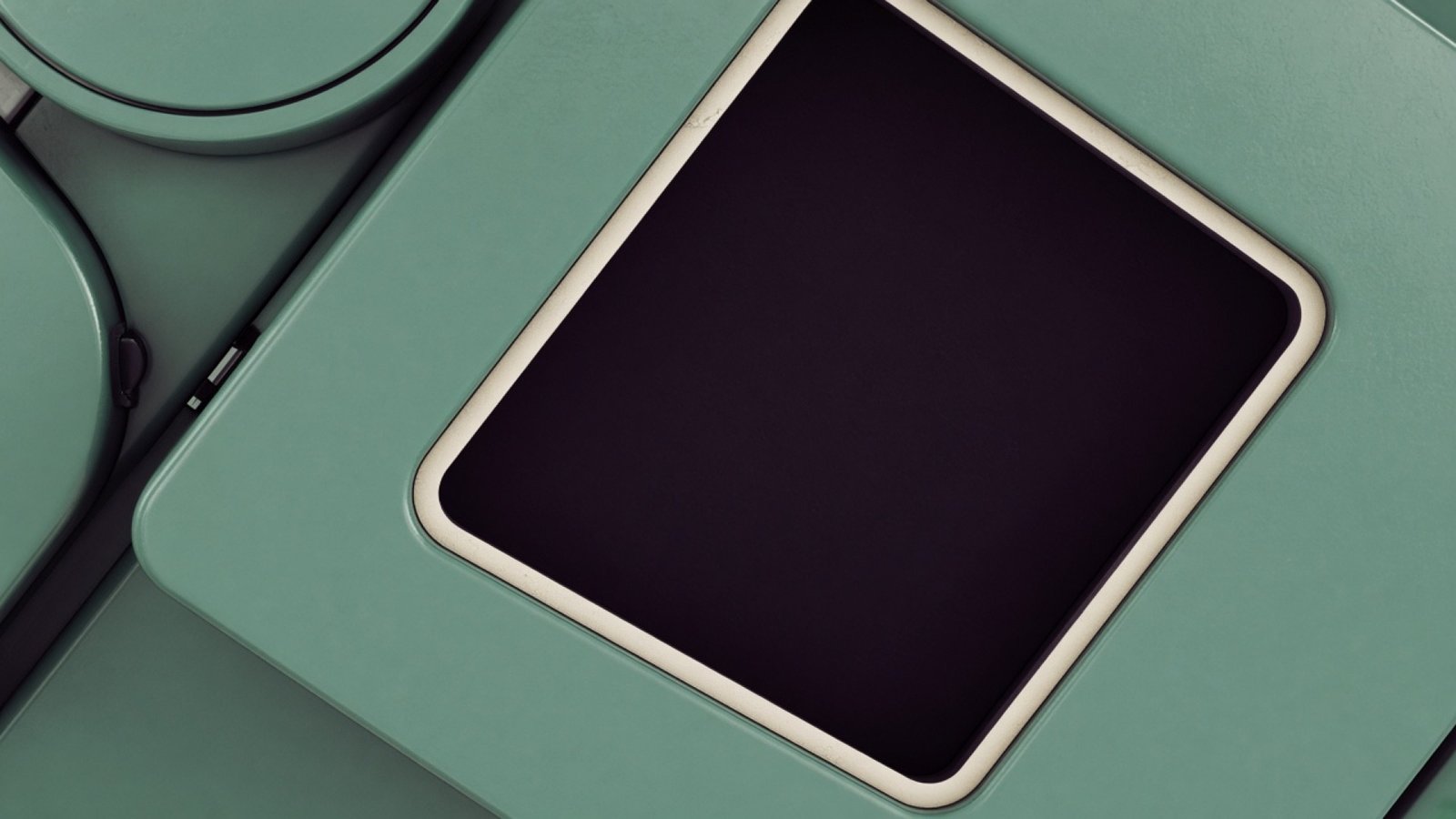 Seafoam enamel surface with a dark rectangular inset.