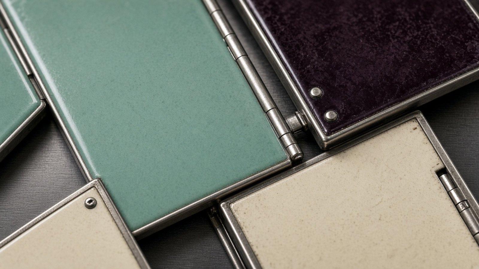 Segmented enamel display plates in seafoam, mulberry, and cream.